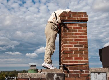 An Ontario SwiftWatch volunteer peers into a chimney.