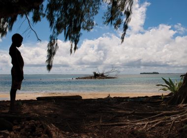 Silhouette of a boy on a beach in Papua New Guinea. A\J AlternativesJournal.ca