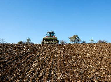 Tractor sowing seeds on a field.